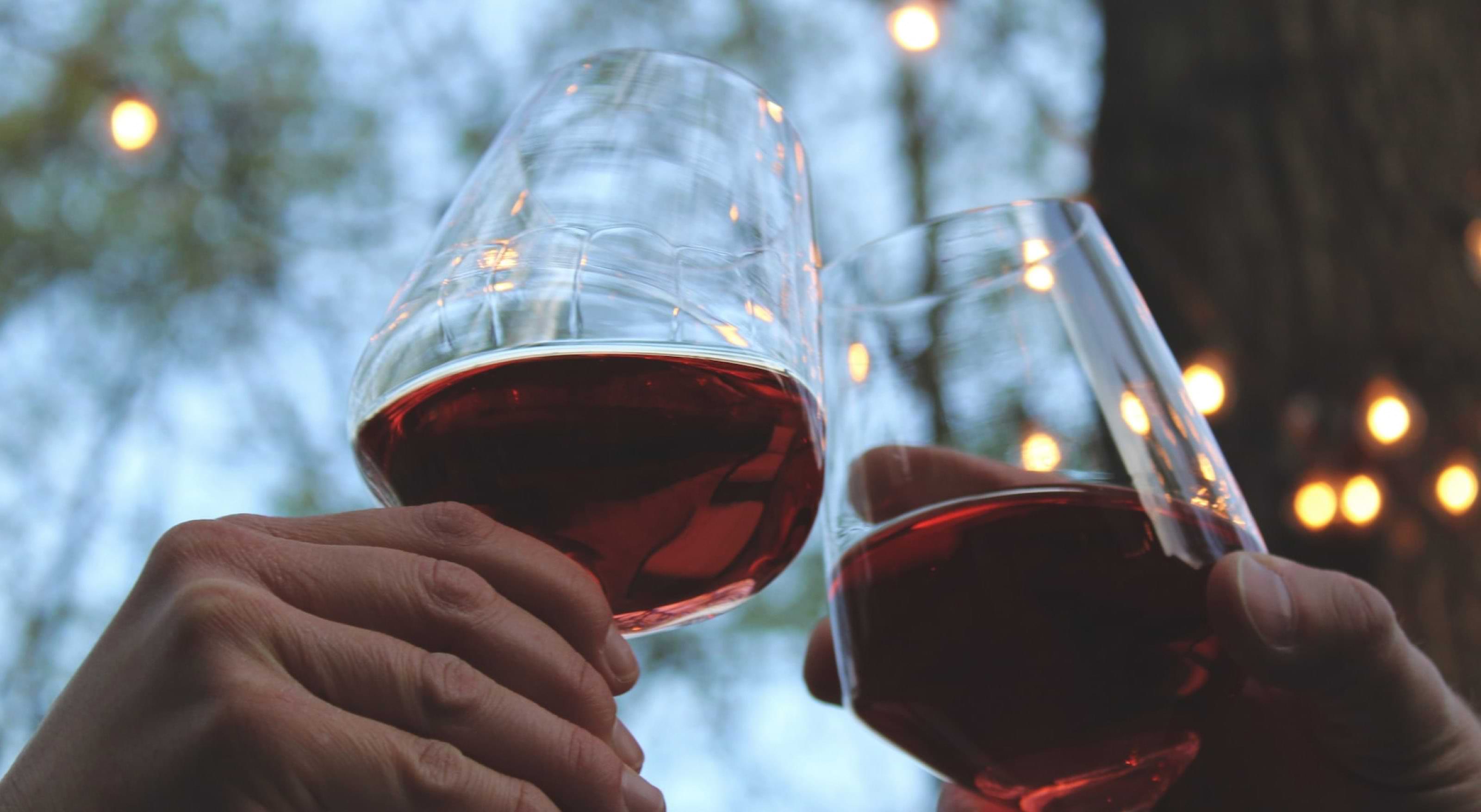 2 Wine glasses raised and clinking