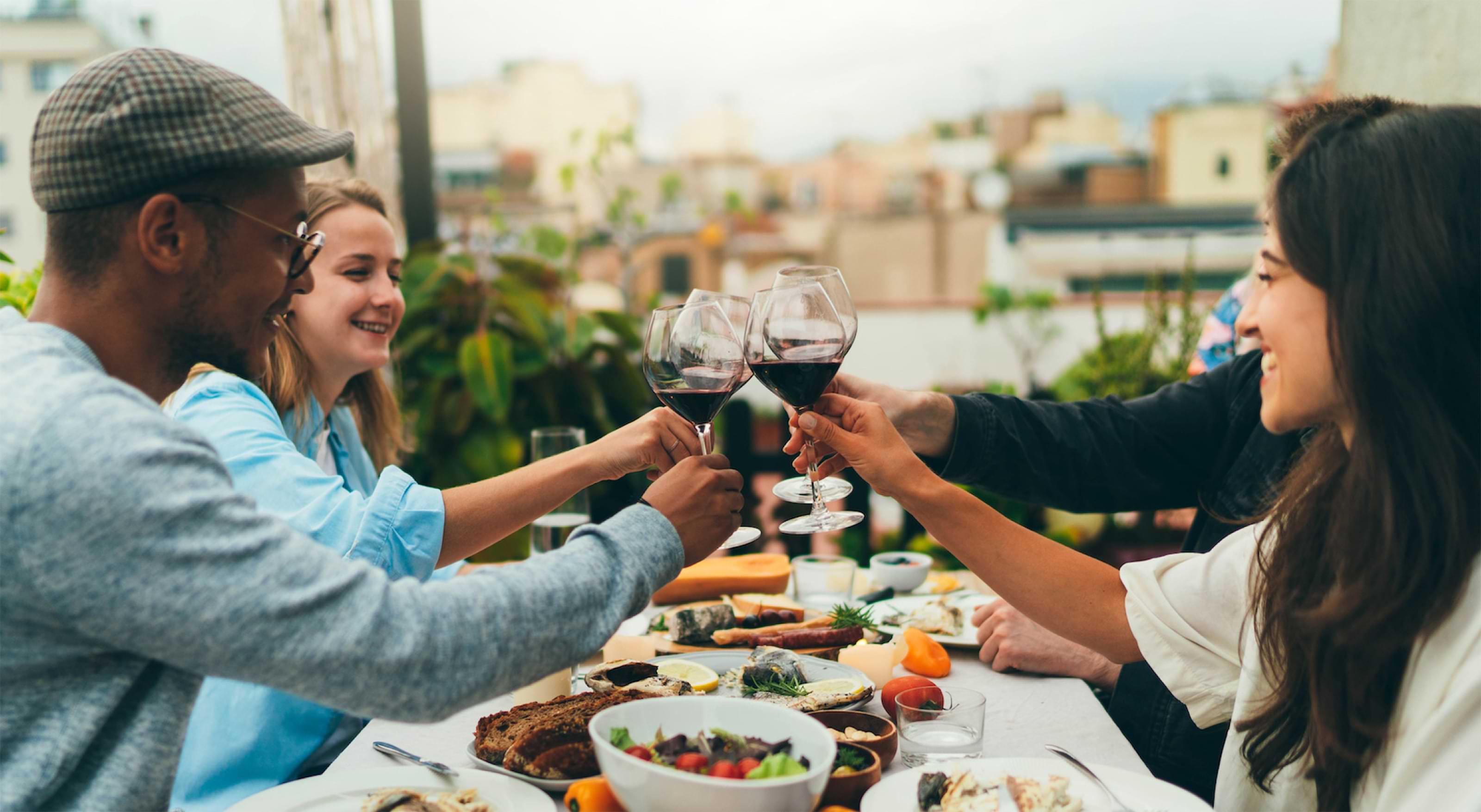 People around a table raising wine glasses