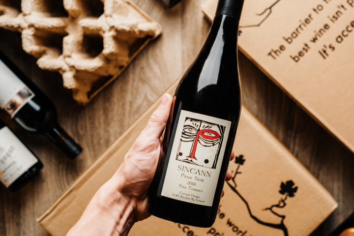 Hand holding a bottle of wine